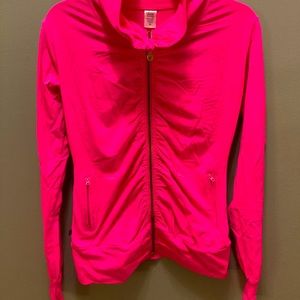 Very vibrant hot pink zip up with gold zipper. It gathers around the zipper.